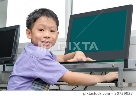 Asian schoolboy using computer in class 20729022