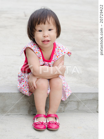 Little Asian girl sitting and smiling outdoor Little Asian girl sitting and smiling outdoor 20729422