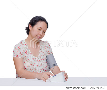 Asian woman checking her blood pressure by herself Asian woman checking her blood pressure by herself 20729452