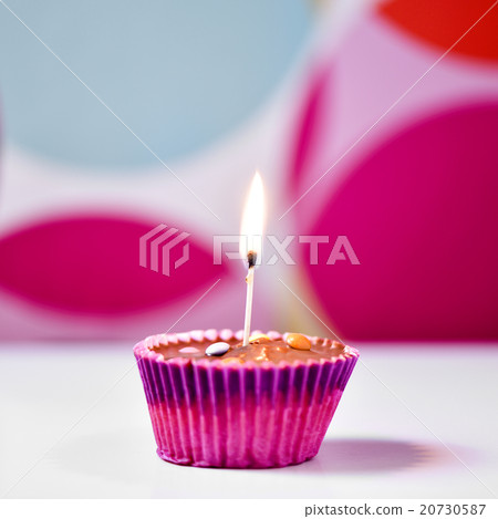 cupcake topped with a lighted match 20730587