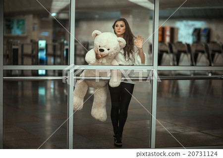 Behind the glass is a girl with  sad face. 20731124
