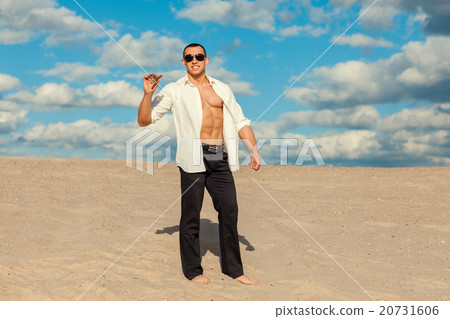 Man with cigar in the desert. Man with cigar in the desert. 20731606