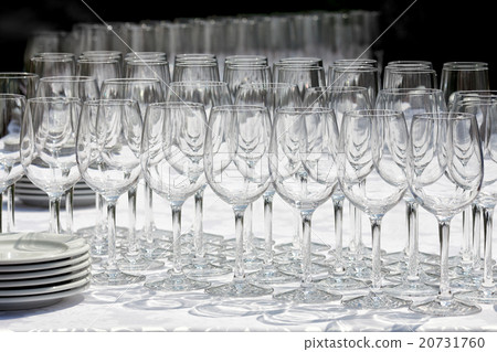 Wine glasses with plates on the table.  20731760