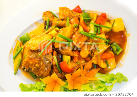 Fried fish with vegetables on the plate.  20732704