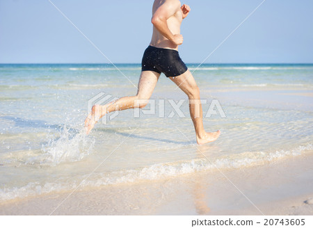 Man running on the beach Man running on the beach 20743605