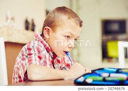 Boy is doing homework 20746676