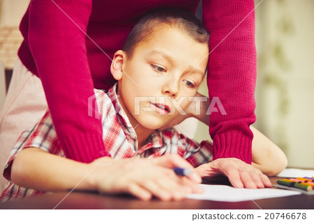 Boy is doing homework 20746678