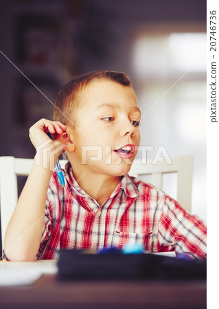 Boy is doing homework 20746736