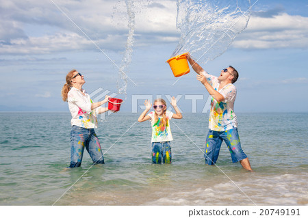 Happy family playing on the beach at the day time. Happy family playing on the beach at the day time. 20749191
