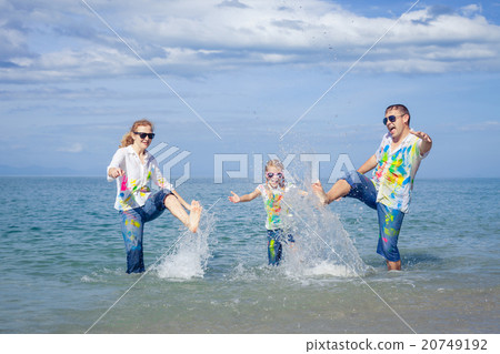 Happy family playing on the beach at the day time. 20749192