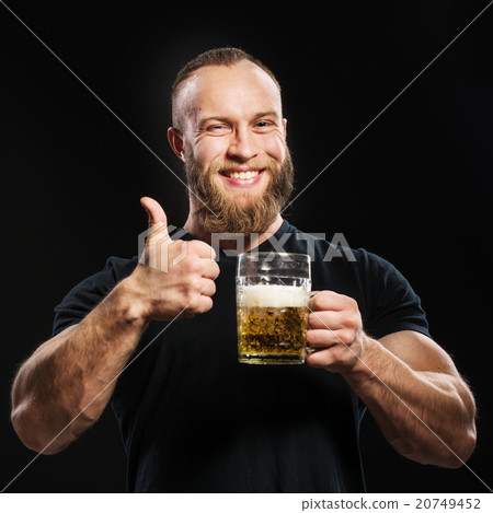 Bearded man drinking beer from a beer mug Bearded man drinking beer from a beer mug 20749452