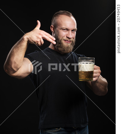 Bearded man standing with a mug of light beer 20749453