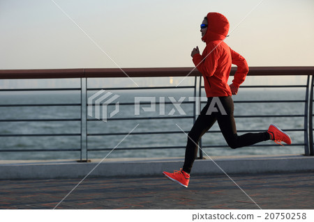 young fitness woman runner running at seaside 20750258
