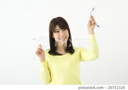 A woman who compares LAN cables with both hands A woman who compares LAN cables with both hands 20751320