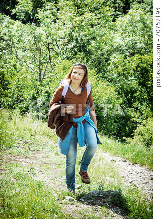 Young tourist woman is hiking in summer nature 20752193
