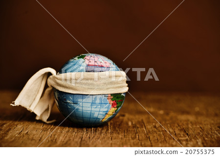 piece of cloth tied around a terrestrial globe 20755375