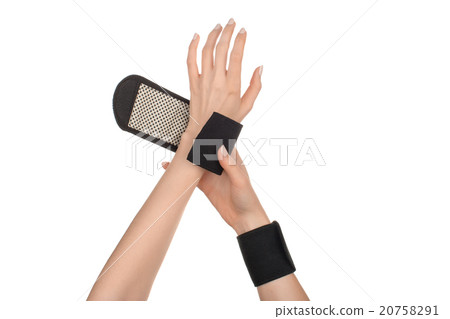 Female hands wearing sports, medical wristbands 20758291