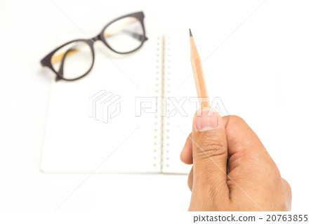 Hand holding a pencil with notebook Hand holding a pencil with notebook 20763855