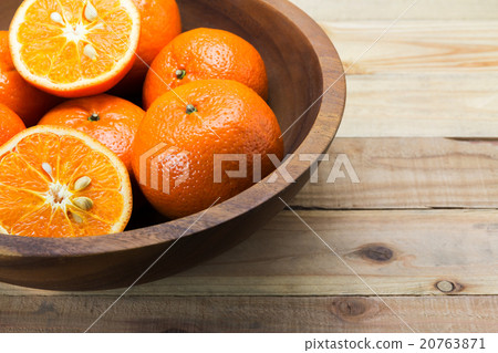 Fresh oranges in wooden bowl. 20763871