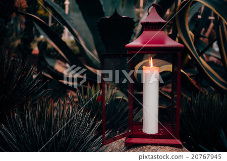 One burning candle on a nature background. One burning candle on a nature background. 20767945