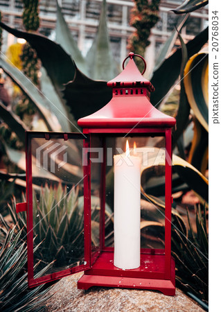 One burning candle on a nature background. One burning candle on a nature background. 20768034