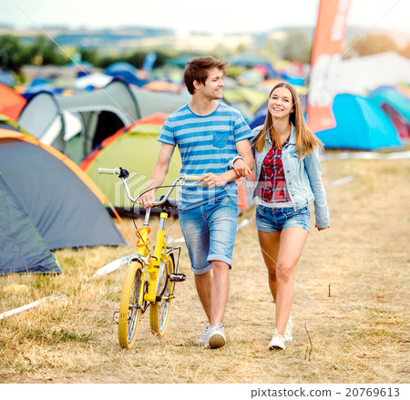 Teenage couple with yellow bike at summer music Teenage couple with yellow bike at summer music 20769613
