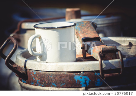 white steel mug on metal cans 20776017