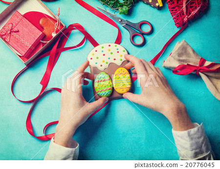 Female hands are holding Easter cookie 20776045