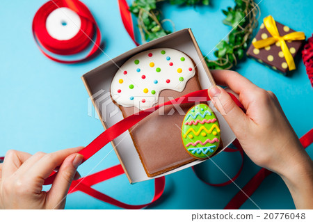 Female hands are holding Easter cookie 20776048