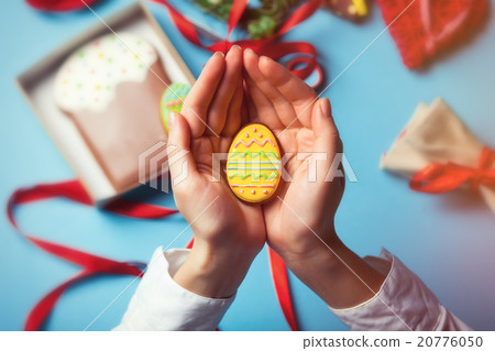 Female hands are holding Easter cookie 20776050