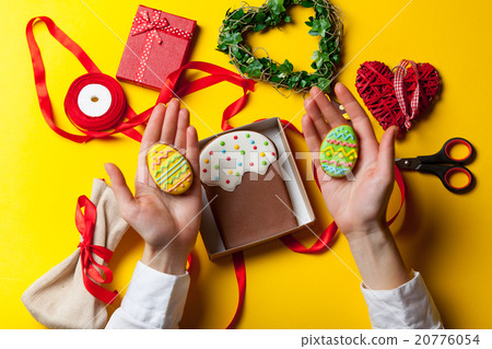 Female hands are holding Easter cookie 20776054