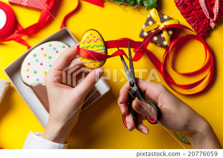 Female hands are holding Easter cookie 20776059