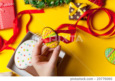 Female hands are holding Easter cookie 20776060