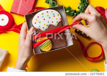 Female hands are holding Easter cookie 20776061