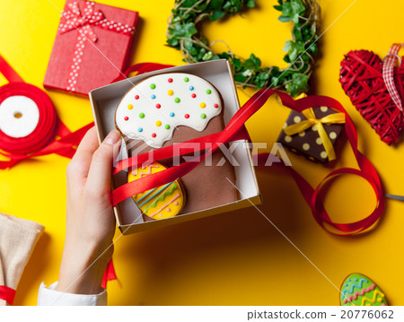 Female hands are holding Easter cookie 20776062