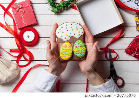 Female hands are holding Easter cookie 20776076