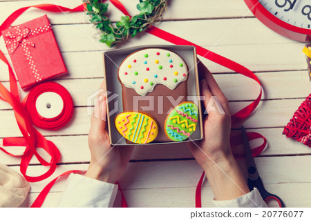 Female hands are holding Easter cookie 20776077