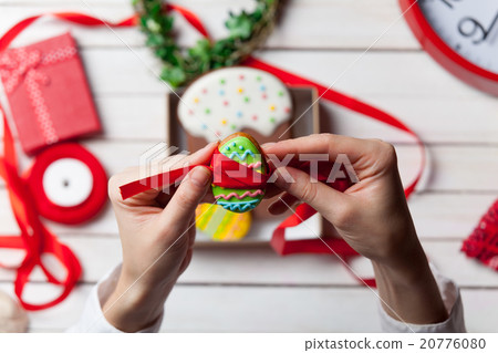 Female hands are holding Easter cookie 20776080