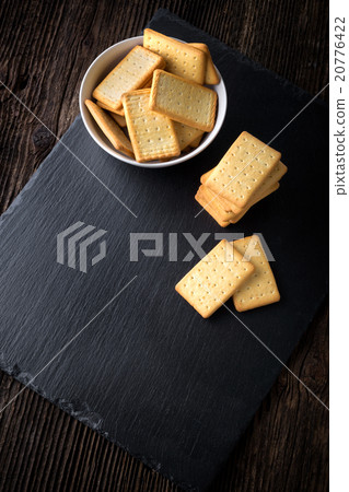 dry salted crackers in a bowl on granite plate dry salted crackers in a bowl on granite plate 20776422