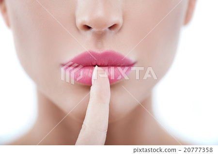 Pretty young woman is gesturing secretly Pretty young woman is gesturing secretly 20777358