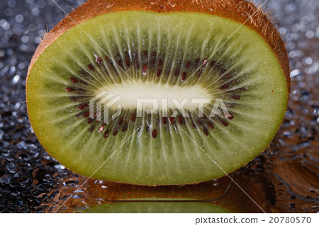 Half kiwi with water drops close-up. 20780570