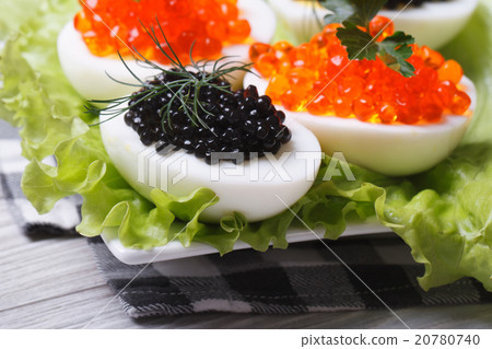 Chicken eggs with red and black fish caviar 20780740