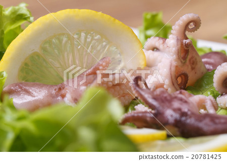small octopus on a plate with lemon and lettuce small octopus on a plate with lemon and lettuce 20781425