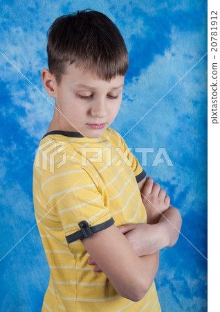 Portrait of sad kid on blue background Portrait of sad kid on blue background 20781912