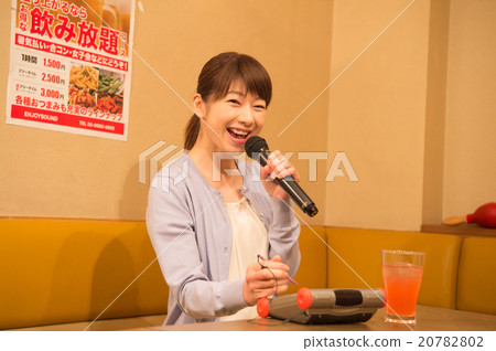 A woman singing karaoke A woman singing karaoke 20782802
