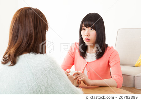 A woman talking with a friend A woman talking with a friend 20782889