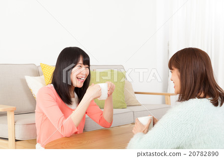 A woman talking with a friend A woman talking with a friend 20782890