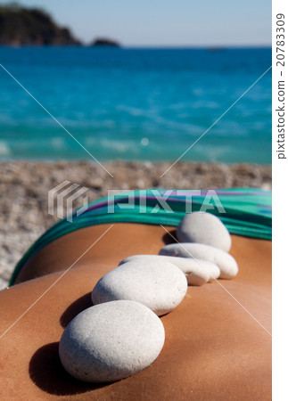Beautiful woman getting hot stones treatment 20783309