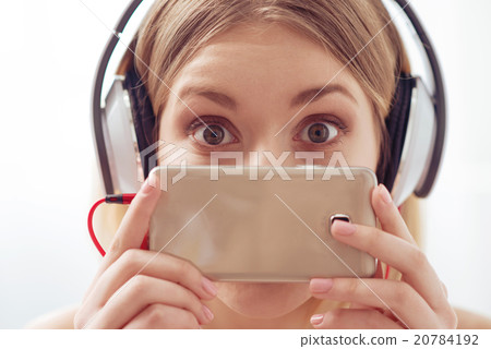 Using smartphones and earphones is popular Using smartphones and earphones is popular 20784192