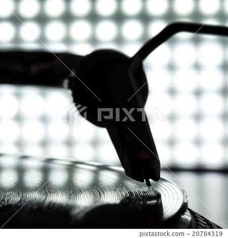 Dj needle stylus on record, blur light background 20784319